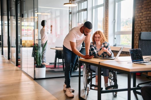 An African American man engages in discussion with his young business colleague about business projects in a modern office setting, reflecting collaboration and innovation in the workplace.