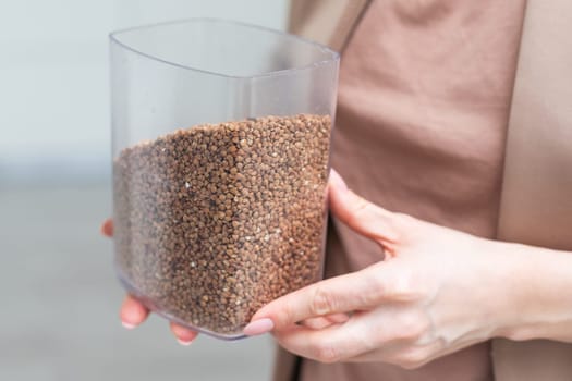 Hands holding buckwheat seeds, close-up . High quality photo