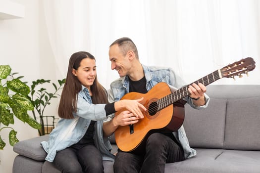 Happy family Father and daughter playing guitar. Father's day. High quality photo