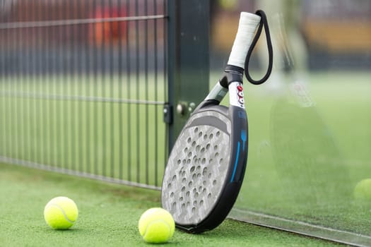 paddle tennis racket and balls on court . High quality photo