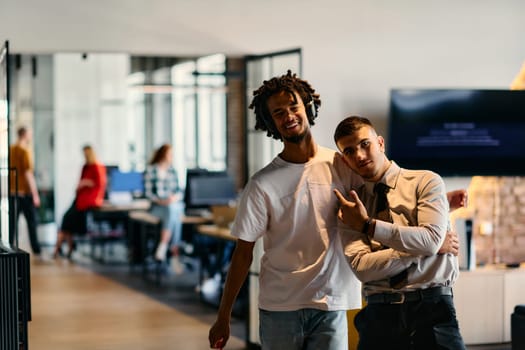 A group of colleagues, including an African American businessman and a young leader in a shirt and tie, pose together in a modern coworking center office, representing a dynamic blend of professionalism and collaboration.