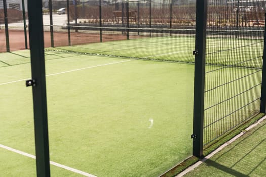 Tennis court with green grass and net outdoors. High quality photo