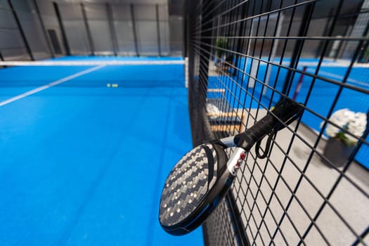paddle tennis racket and balls on court, night image. High quality photo