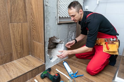 Plumber working in the bathroom. High quality photo