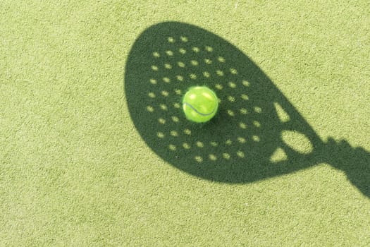Paddle tennis racket shadow on balls. High quality photo