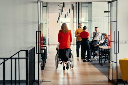 A businesswoman assists her colleague in a wheelchair as they navigate the sleek hallways of a modern startup office, embodying inclusivity and teamwork.