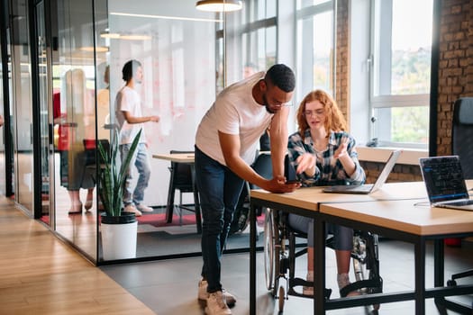 An African American man engages in discussion with his young business colleague about business projects in a modern office setting, reflecting collaboration and innovation in the workplace.