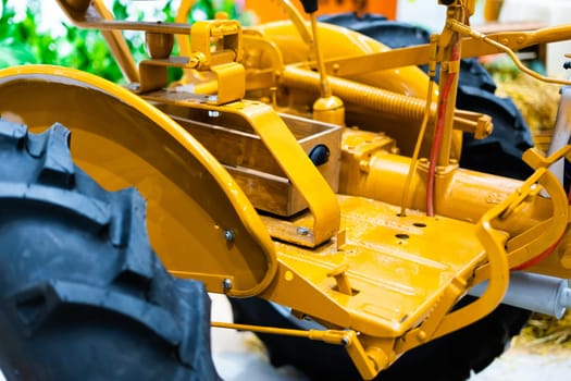 Detail of small tractor with yellow construction tracks, Caterpillar Ten