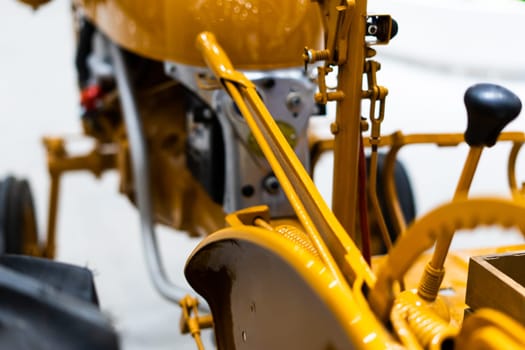 Detail of small tractor with yellow construction tracks, Caterpillar Ten