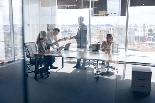 Creative business people working on project in modern office with panoramic view. Teamwork concept