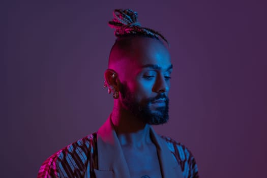 Retro wave or synth wave portrait stylish serious african-american man studio shoot. High Fashion male model in colorful bright neon lights posing. Art design concept