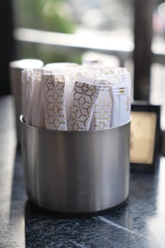 white sugar in a paper packet on table .