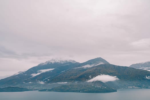 Misty forested mountain range on the shore of Lake Como. Italy. High quality photo