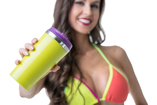 Focus on shaker in hands of charming smiling woman, close-up