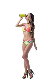 Fitness. Sexy model in bright bikini drinks protein shake