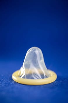 close-up of a condom on a blue background.