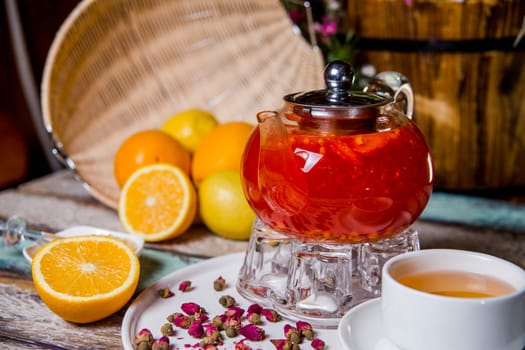 berry sea buckthorn tea in a glass teapot in a cafe.