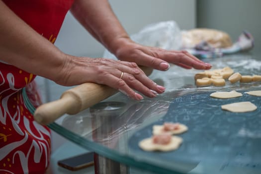 homemade cooking of dumplings with women's hands in the kitchen