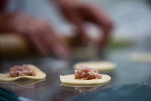 the stage of cooking dumplings with meat. dough with minced meat.