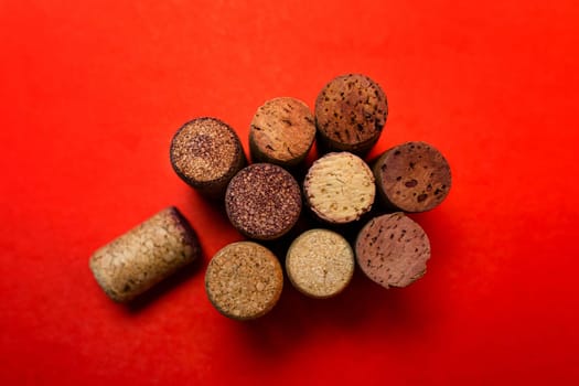 wine corks on a red background top view.