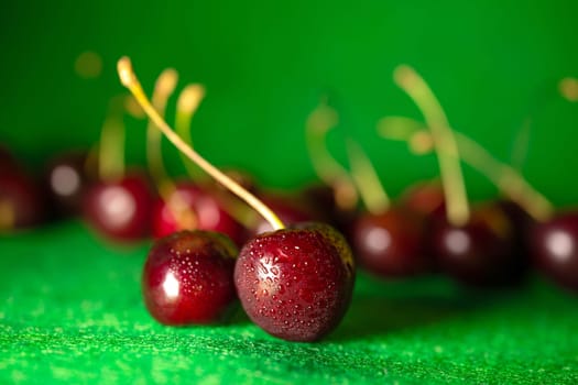 ripe red cherry on a green background