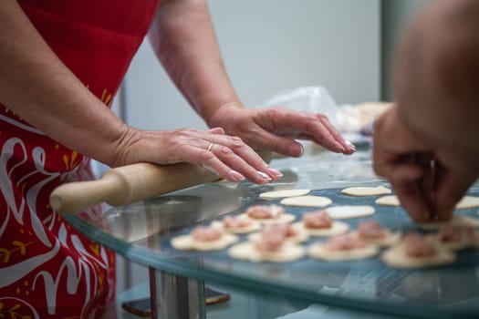 cooking dumplings at home in the kitchen at the table.