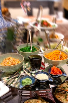 spicy salads of the cafe on the buffet table.