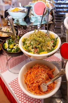 spicy salads of the cafe on the buffet table.