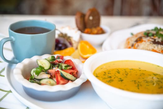 Business lunch in a cafe. set of soup and pilaf and tee