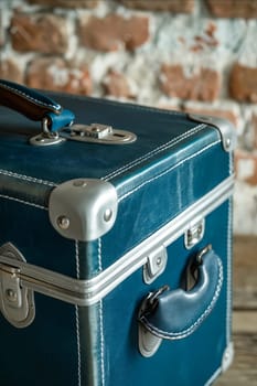 A blue leather suitcase with a silver clasp sits on a wooden table. Generative AI