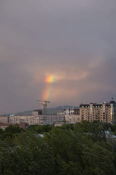 rainbow after rain on a summer day view from the window.