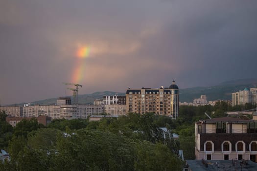 rainbow after rain on a summer day view from the window.