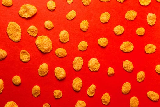 background of cornflakes on a red background