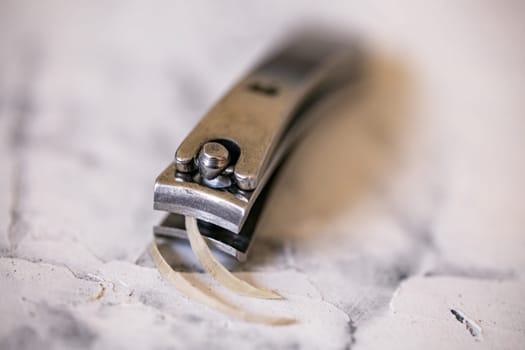 close up nail clippers with human fingernail