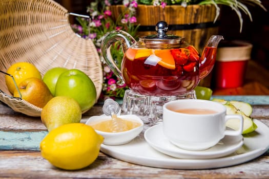 red fruit tea with pomegranate and white cup on the table.