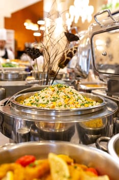 steamed rice with corn and green onions in a saucepan.