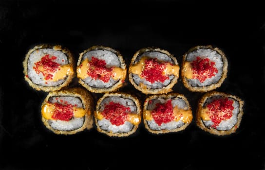 baked Japanese rolls with red caviar. top view.