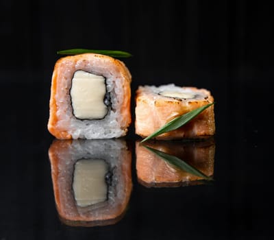 rolls with reflection on black background, photo for menu design