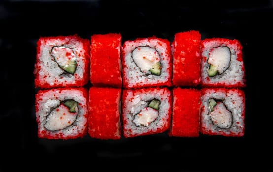 Photo for the menu. japanese rolls with red caviar top view.