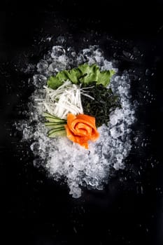 fish fillet cut on ice on a black background