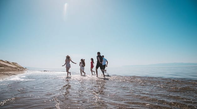 company running along the shore on a summer day.