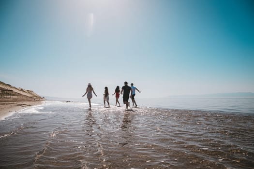 company running along the shore on a summer day.