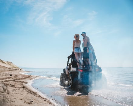 quad bike with people rides on the shore