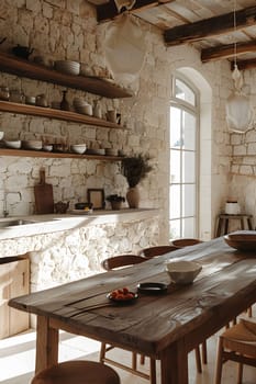 A kitchen with a wooden table and chairs, hardwood flooring, and a stone wall. The room includes a window, shelf, and other furniture made of wood