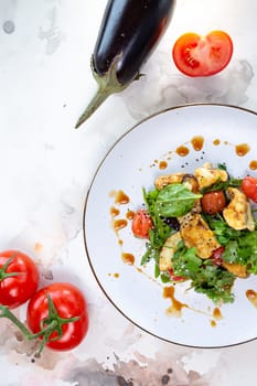 Delicious and healthy vegetable salad with grilled eggplant, spinach, and tomatoes. Perfect for a light lunch or side dish.