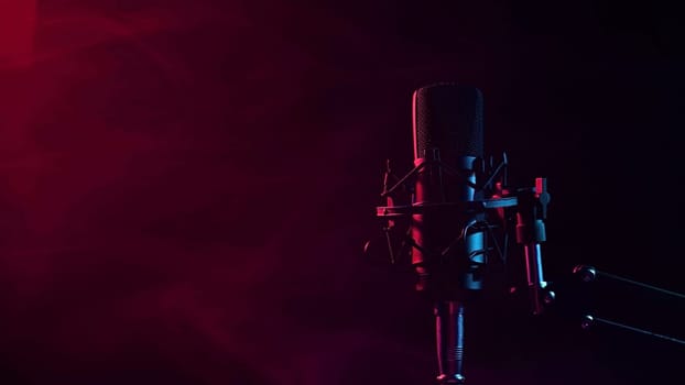 Professional microphone in red smoke on a black background