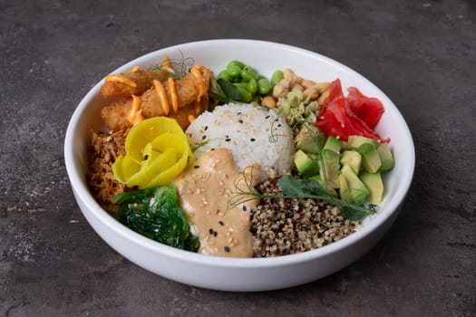 A delicious and healthy poke bowl filled with fresh ingredients like avocado, cucumber, edamame, carrots, and salmon.