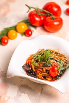 A delicious and healthy meal of Japchae, made with sweet potato noodles, vegetables, and a savory sauce, garnished with tomatoes and dill