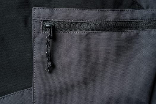 Drawstring zipper of dark gray outdoor trouser pocket