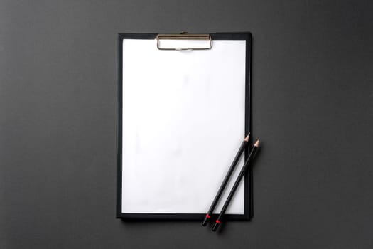 Blank A4 paper attached to the clipboard and pencil on it